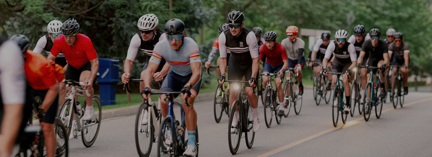 Cycling Team riding their bikes in race wearing custom team uniforms