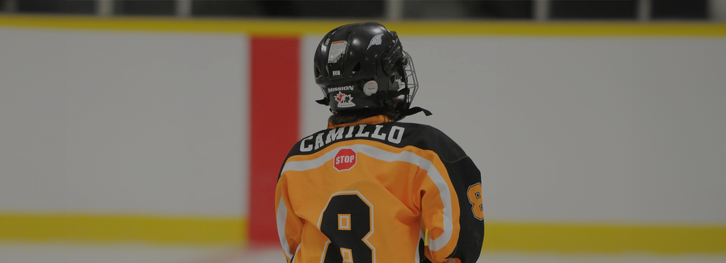 Youth hockey player wearing custom team jerseys skating on the ice